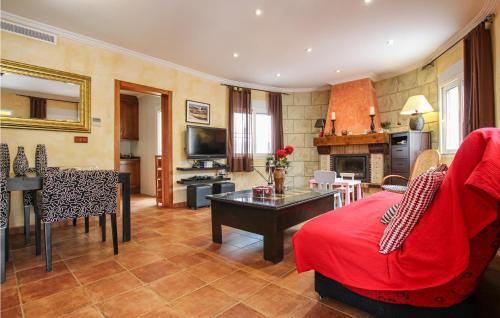 a living room with a red couch and a table at Cozy Home In Orihuela in Orihuela