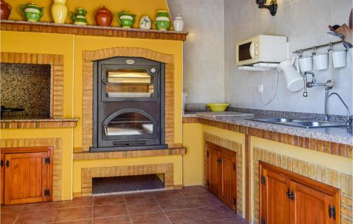 a kitchen with a yellow oven in a kitchen at Cozy Home In Orihuela in Orihuela