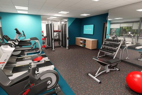 a gym with treadmills and machines in a room at Avid Hotels - Cincinnati N - West Chester by IHG in West Chester