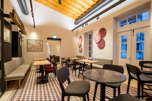 a restaurant with tables and chairs in a room at Hotel Indigo Larnaca by IHG-ADULTS ONLY in Larnaka