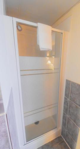 a glass shower door in a bathroom at Canad Inns Destination Centre Fort Garry in Winnipeg