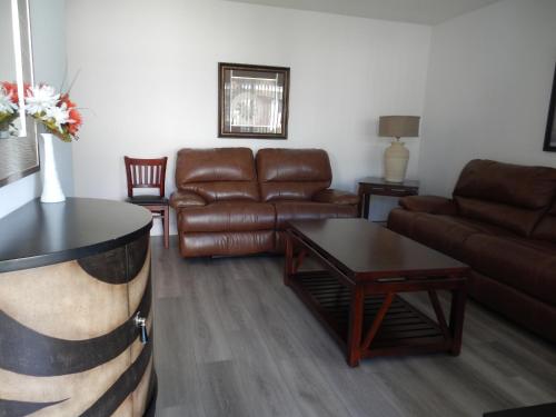 a living room with a couch and a table at Shell Motel Hollywood in Hollywood