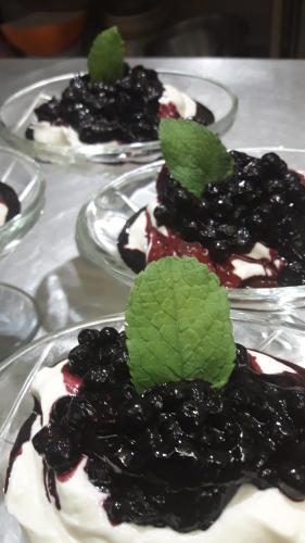 three plates of desserts with blackberries and whipped cream at Chambres d'hôtes L'Astazou in Gavarnie