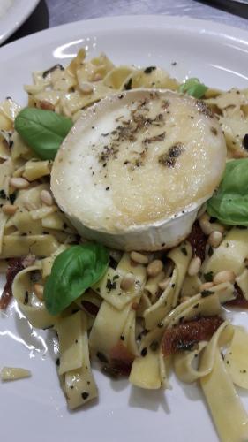a plate of pasta with an egg on top at Chambres d'hôtes L'Astazou in Gavarnie