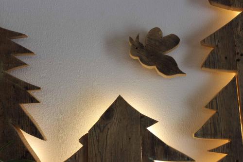 a clock on a ceiling with a bird on it at Apartment Monolith Black Forest in Schonach