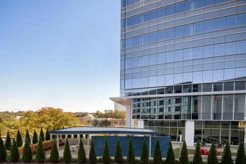 a tall glass building with a garden in front of it at Hyatt Place Atlanta/Perimeter Center in Atlanta