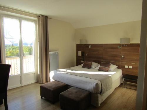 a bedroom with a large bed and a large window at Fifi Moulin in Serres