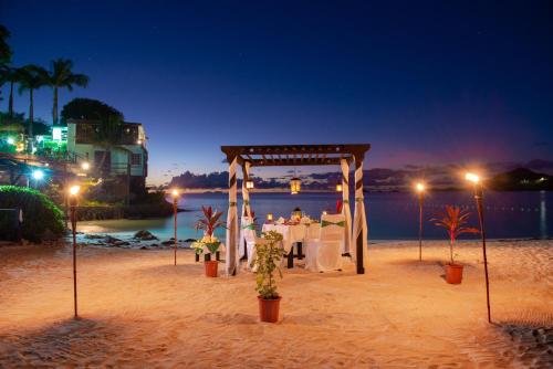 a wedding set up on the beach at night at COCOS Hotel Antigua - All Inclusive - Adults Only in Bolans
