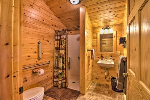 a bathroom with a shower toilet and a sink at Rural Cabin Hideaway with Fire Pit and Mtn Views! in Parsons