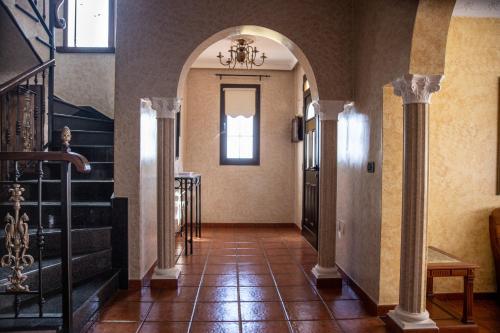 a hallway with columns and a staircase in a building at VILLA LAS CUEVAS in Tías