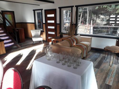 a living room with a table with glasses on it at The Patagonian Lodge in Coihaique