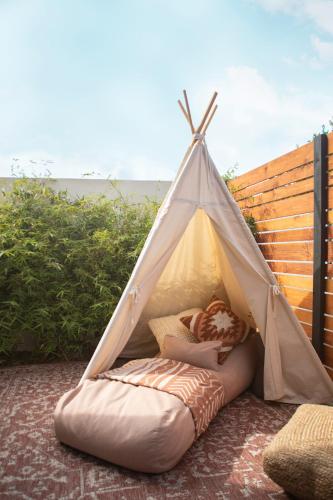 a iguana tent with pillows on the ground at Haven Coliving in Los Angeles