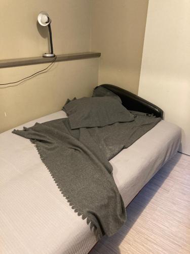 a bed with a blanket on it in a room at Apartamenti in Cēsis