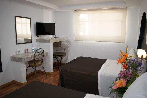 Säng eller sängar i ett rum på Hotel Santiago