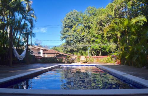 a swimming pool in the yard of a house at Pousada do Roballo in Arraial d'Ajuda