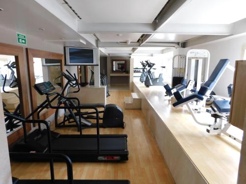 a gym with treadmills and elliptical machines at Hotel Palacio Azteca in Tijuana