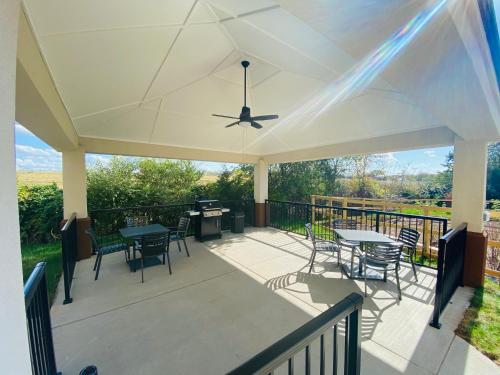 a covered deck with tables and chairs and a ceiling fan at Candlewood Suites - Lebanon by IHG in Lebanon