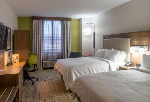 a hotel room with two beds and a desk at Holiday Inn Express - Grand Island, an IHG Hotel in Niagara Falls