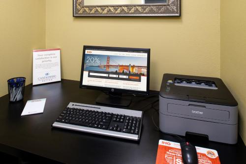 a desk with a computer and a printer on it at Candlewood Suites Olathe, an IHG Hotel in Olathe
