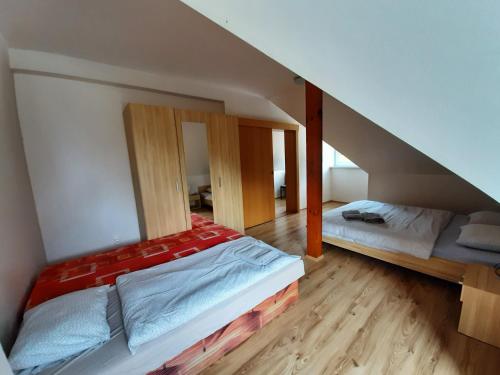 a room with two beds in a attic at Apartman Horec 30 a 1 in Donovaly