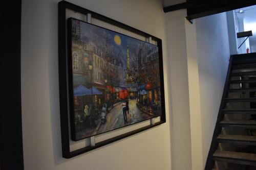 a painting hanging on a wall on a wall at El Suburbio - Morelos Sur in Morelia