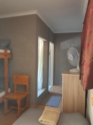 a small room with a bed and a window at Denmark Farm Stay in Cradock