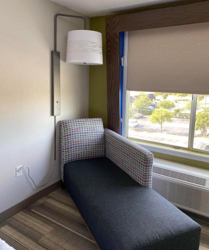 a couch sitting in a room with a window at Holiday Inn Express & Suites Columbia-I-26 @ Harbison Blvd by IHG in Columbia
