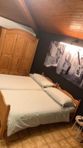 a bedroom with a bed with two pillows on it at Borgovecchio Albergo in Balerna
