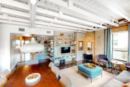 a living room with a couch and a table at East 6th Historic Loft in Austin