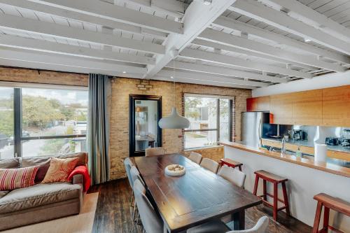 a kitchen and living room with a wooden table at East 6th Historic Loft in Austin