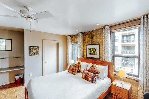 a bedroom with a white bed and a window at East 6th Historic Loft in Austin