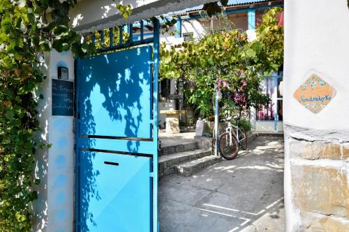 a blue door in the side of a building at Andrebyke in Gergei