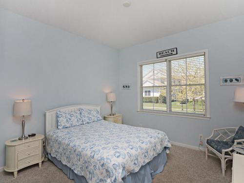a white bedroom with a bed and a window at Bayside Resort - 36477 Wild Rose in Selbyville
