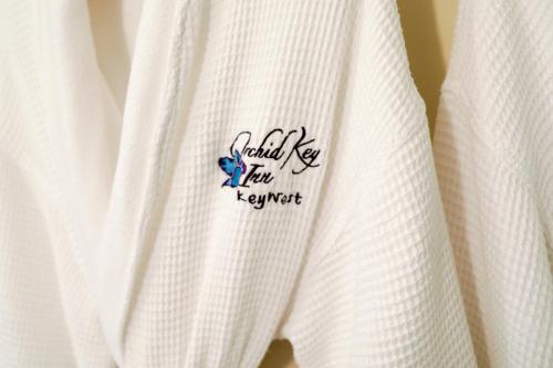 a close up of a white shirt with a blue logo at Orchid Key Inn - Adults Only in Key West