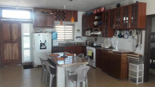 a kitchen with wooden cabinets and a white refrigerator at La casa del Argentino in Hawaii