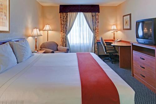 a hotel room with a large bed and a television at Holiday Inn Express Las Vegas-Nellis, an IHG Hotel in Las Vegas