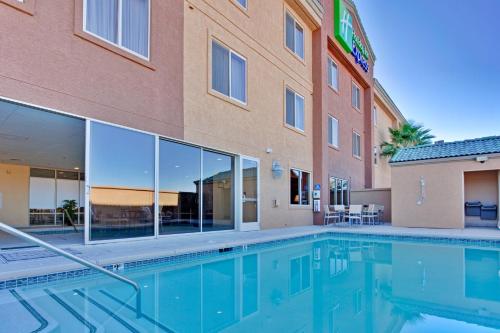 
a large swimming pool in a large building at Holiday Inn Express Las Vegas-Nellis, an IHG Hotel in Las Vegas
