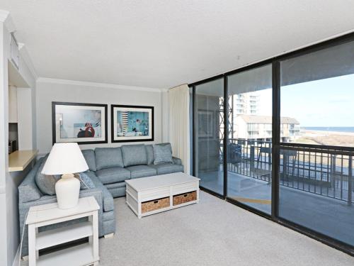 a living room with a couch and a view of the ocean at Sea Colony Chesapeake House III in Bethany Beach