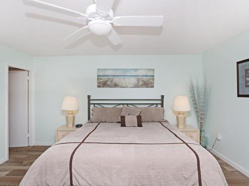a white bedroom with a bed with a ceiling fan at Sea Colony Edgewater House VI in Bethany Beach