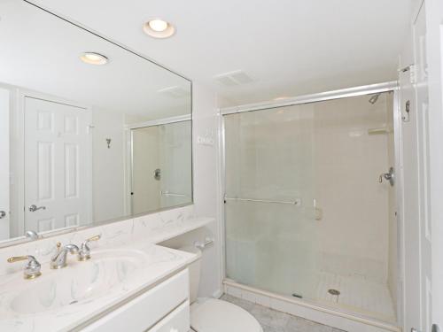 a white bathroom with a shower and a sink at Sea Colony Annapolis House in Bethany Beach