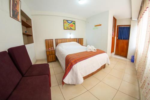 a bedroom with a bed and a couch at Inka's Rest Hostel in Puno