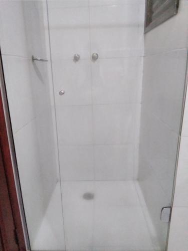 a shower with a glass door in a bathroom at Hotel Saint Paul 01 Flat in Manaus