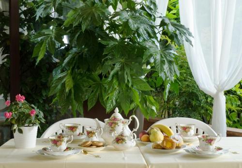 a table with a tea set with fruit on it at Hotel Ferro di Cavallo in Pavullo nel Frignano
