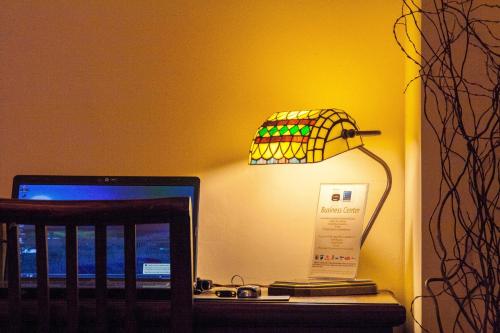 a desk with a laptop computer and a lamp on it at Cases Noves - Boutique Accommodation - Adults Only in Guadalest