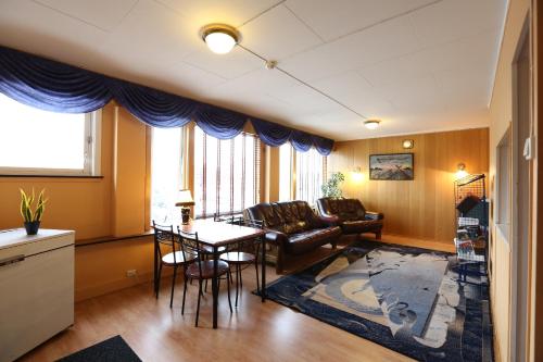 a living room with a couch and a table at Barents Hotell in Kirkenes