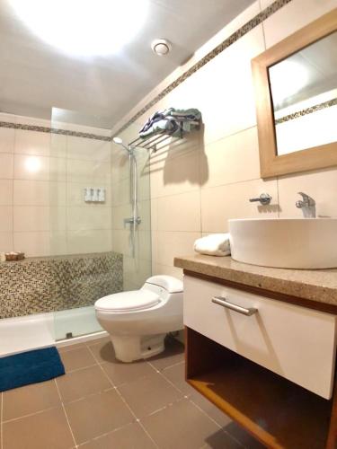 a bathroom with a toilet and a sink and a shower at Beach front Apt at Juan Dolio Marbella Apt Frente al mar 702 in San Pedro de Macorís