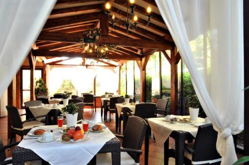 a dining room with tables and chairs in a building at Hotel Ferro di Cavallo in Pavullo nel Frignano