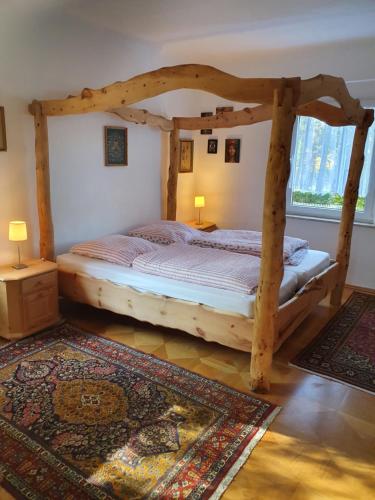 a bedroom with a wooden bed in a room at Apartmenthaus Am Schlosspark in Schkopau