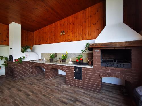 a brick fireplace in a living room with wooden ceilings at Amso Residence in Sibiu