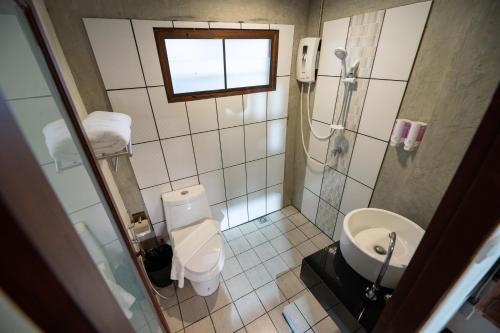 a bathroom with a shower and a toilet and a sink at Chirin Home ฌิรินทร์โฮม in Chiang Mai